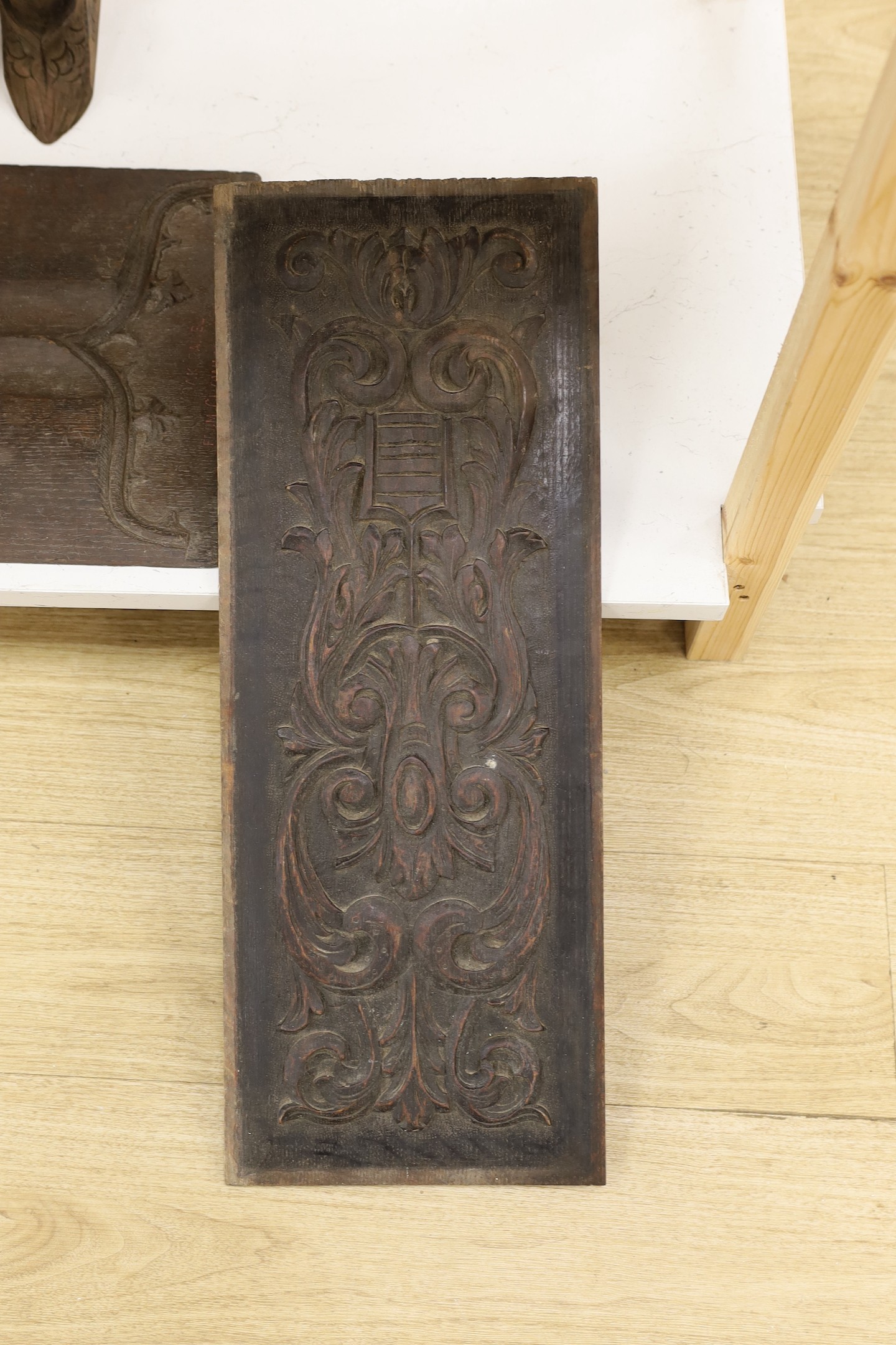 Three carved oak panels and a pair of brackets, one linenfold oak panel carved ‘from Crowland Abbey’, 46 cm X 33 cm